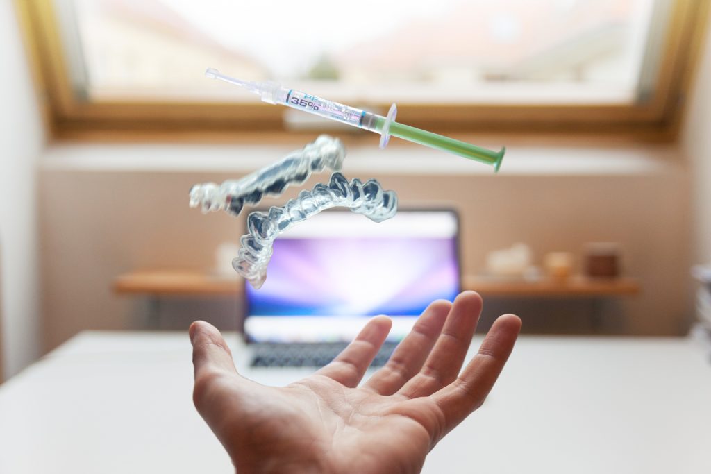 syringe floating above an exposed hand Peptide Therapy